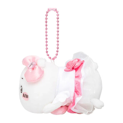 Side view of white plush mini mascot with pink ribbons and pink beaded necklace strap.