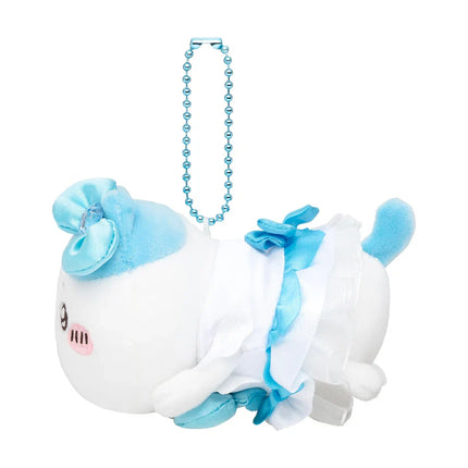 Side view of white plush mini mascot with blue bow and long blue beaded strap.