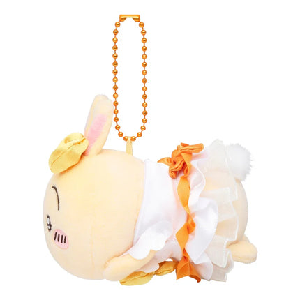 Plush mascot keychain with cream face, layered orange and white ruffle, orange bead strap