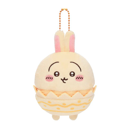 Cream plush Easter mascot hanging charm with orange bunny ears and egg shell outfit