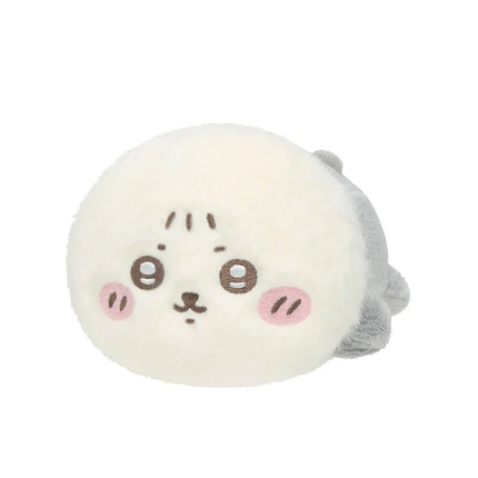 Cream crawling plush toy with embroidered face and small gray side tuft, close-up