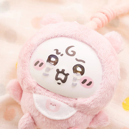 Close-up of a pink plush character face with glossy accents on the eyes