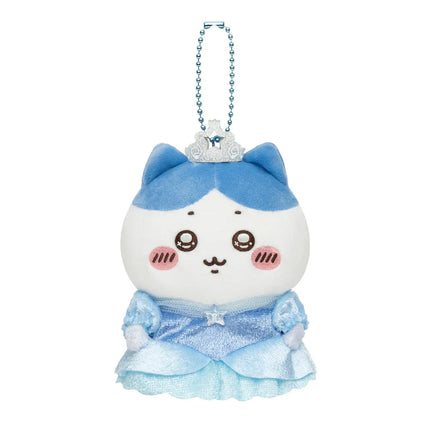 White plush mascot keychain with blue ruffled dress and bead crown, front view.