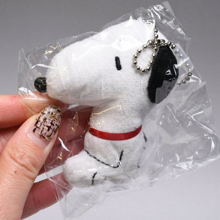 Snoopy plush ball key chain in clear packaging with metal chain