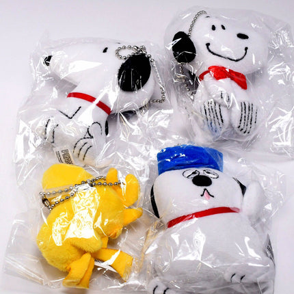 Multiple Snoopy and Woodstock plush ball key chains in clear packaging