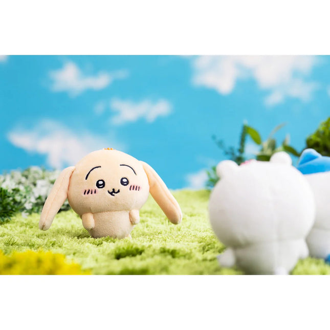 Beige floppy-eared plush rabbit mascot keychain with stitched face and dangling bead chain