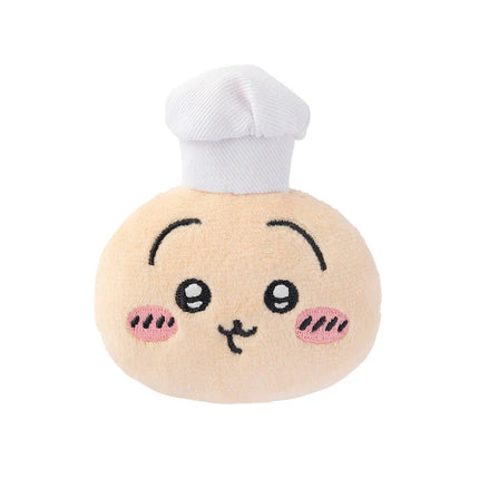 Beige plush chef face badge with white chef hat and smiling embroidered face