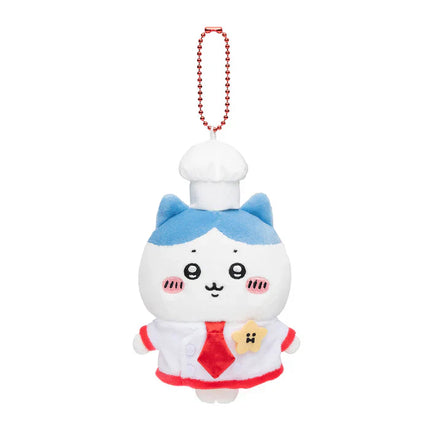 White plush mascot keychain with red beaded necklace, blue chef cap and red apron