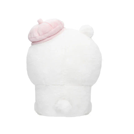 Back view of white sitting plush toy with a pink hat