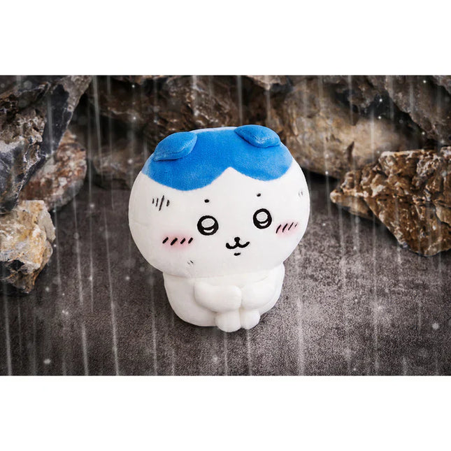 Cute white plush with blue cap, round eyes, and stitched whiskers