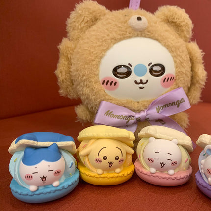 Macaron mascot toys set, featuring a large beige character with blue, yellow, and pink figures