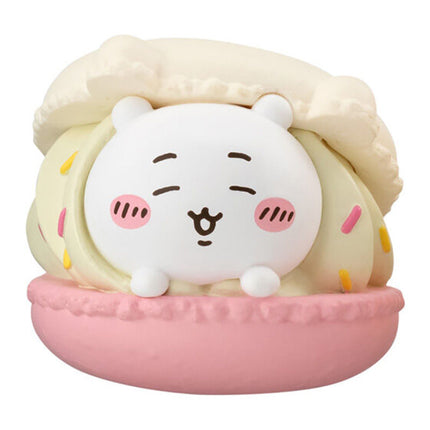 Pink macaron mascot toy with a white face and cream hair-style plush details