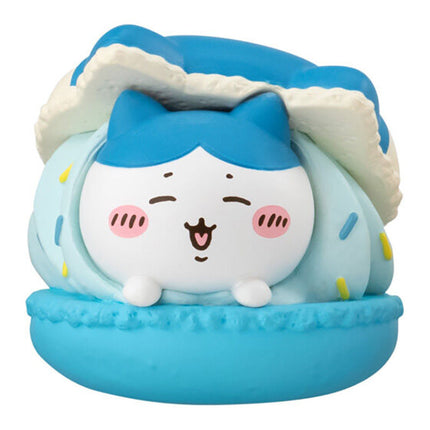 Blue macaron mascot toy with a white face and plush hood with ear-like details