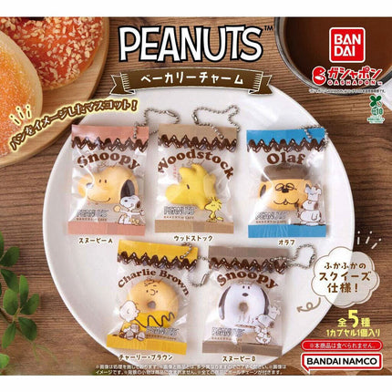 Set of 5 Peanuts bakery character keychain charms in individual blister packs on a tray