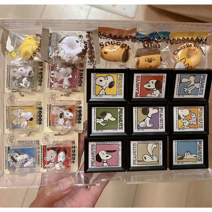 Assorted Peanuts bakery character charm keychains displayed in retail packaging cards