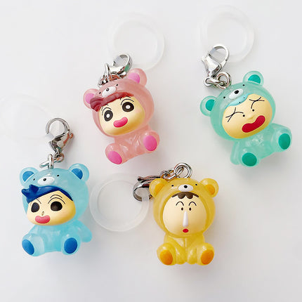 Five chibi character keychains with white loops, wearing colorful pajama outfits