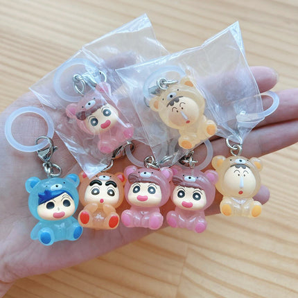 Five chibi pajama character keychains in small clear bags, each with metal ring
