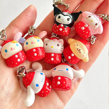 Set of strawberry-themed character keychains with red polka-dot outfits shown in hand