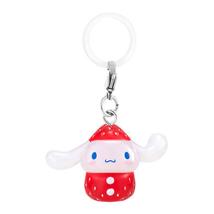 Strawberry-themed white character keychain charm with blue eyes and red polka-dot outfit
