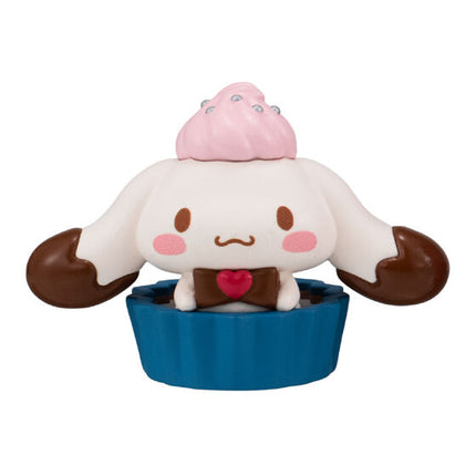 Chocolate cup character doll with white face, pink cheeks, and blue cup base