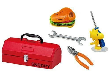 a red toolbox, a toy Snoopy, a toy sandwich, a toy wrench, and a toy pair of pliers.