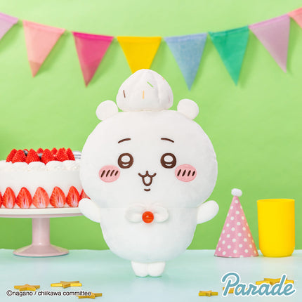 White big plush toy with cat face, head tuft, and a red button on belly.