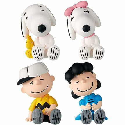 Set of four Peanuts capsule toy figures: two Snoopy and two friends, seated