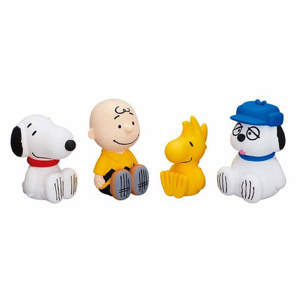 Set of four PEANUTS capsule toy figures lined up: dog, boy, yellow bird, blue-hat dog.