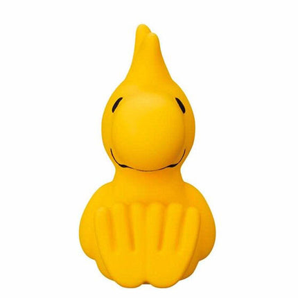 Yellow bird capsule figure with small black nose and beak, with black outline details.
