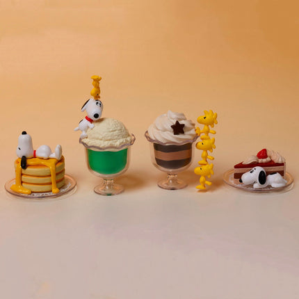 Four Snoopy dessert capsule figures on base: yellow cake, green sundae, brown cup, pie