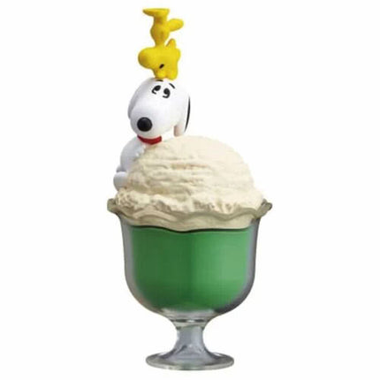 Green sundae capsule figure with Snoopy head and cream topping, yellow charms on stem