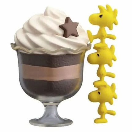 Striped chocolate sundae capsule with star topper and Snoopy, plus yellow character charms