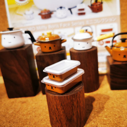 Miniature miffy Boris-face cooking pots on wooden display blocks