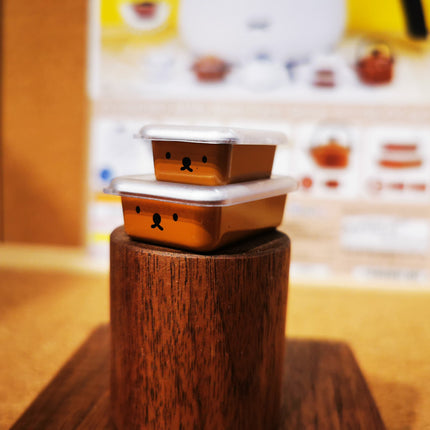 Orange miniature miffy Boris-face storage container with open lid on stand