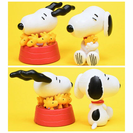 Snoopy and Woodstock figures shown in two poses with red bases