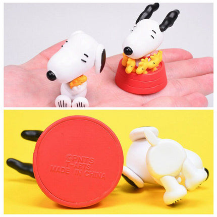 Snoopy and Woodstock figures on hand, plus underside view of red base