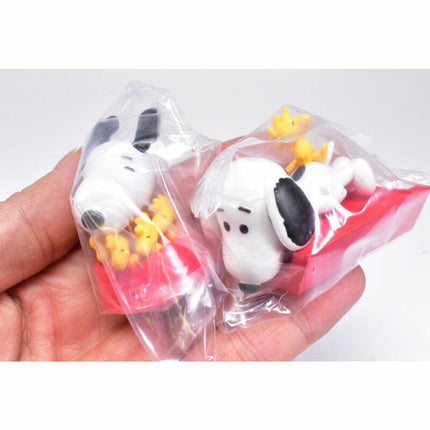 Two Snoopy and Woodstock capsule figures sealed in clear plastic bags