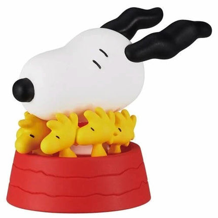 Snoopy figure holding yellow Woodstock with small figures, on a red base