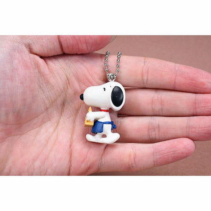 Small Snoopy coffee character keychain charm on silver bead chain held in hand