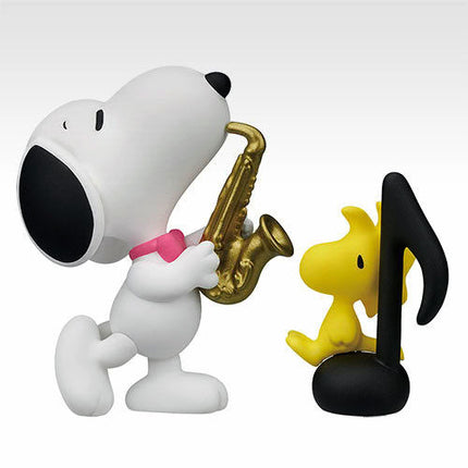 Snoopy saxophone miniature figure, white body with black ears and pink bow