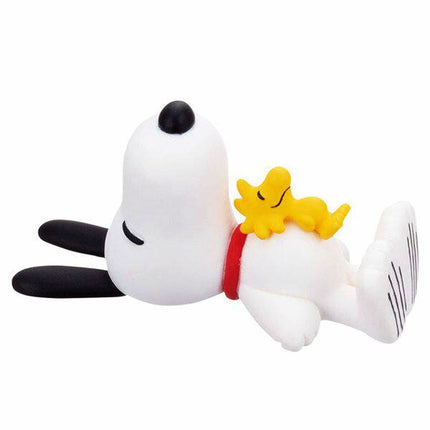 Snoopy capsule mascot figure cuddling a yellow star with red collar
