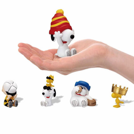 Set of five Snoopy hide-and-seek figures posed on open hands