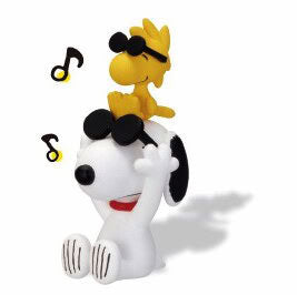 Snoopy hide-and-seek figure with yellow head accessory and music notes