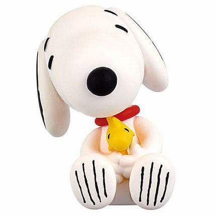 Snoopy sleeping capsule toy figure holding a small yellow chick