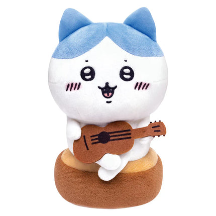 White-faced plush cat holding a brown acoustic guitar with blue ear details