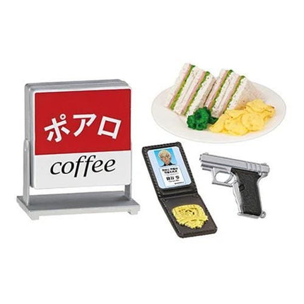 a red sign with the word "coffee", a plate of sandwiches, a wallet, and a gun.