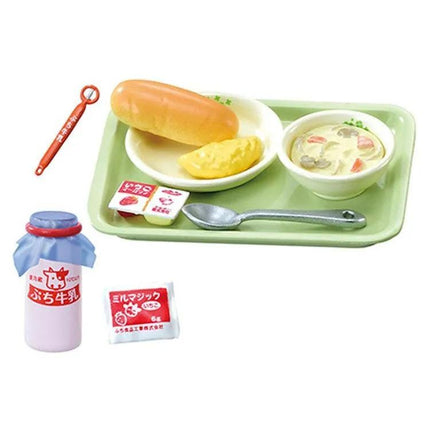 A tray containing a sandwich, soup, and a bottle of yogurt, along with a spoon and a small packet of condiments.