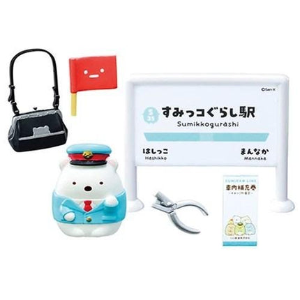 various objects, including a small toy bear, a sign, a handbag, and some other items. The objects are arranged in a way that they appear to be part of a collection or display.