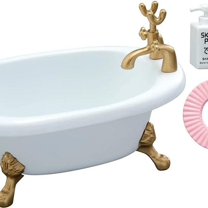 a white clawfoot bathtub with gold accents, accompanied by a pink bath mat and a bottle of shampoo.