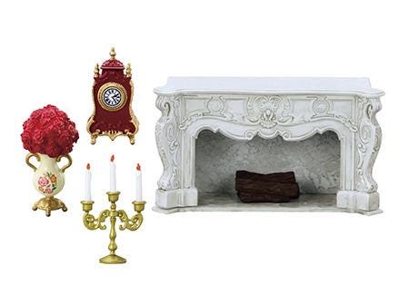 a white fireplace with a mantelpiece, a red clock, a gold candlestick holder with three candles, and a vase with red flowers.
